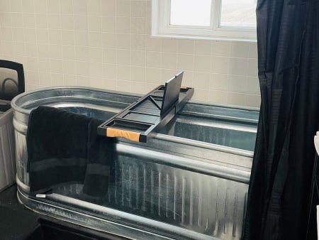 Rustic tiny home bathroom, galvanized steel tub